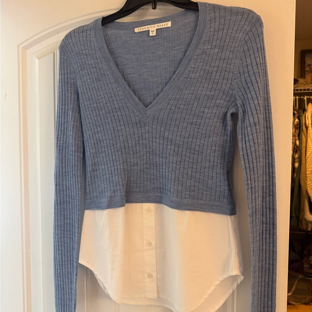Veronica Beard light blue ribbed V-neck sweater with white shirt hem